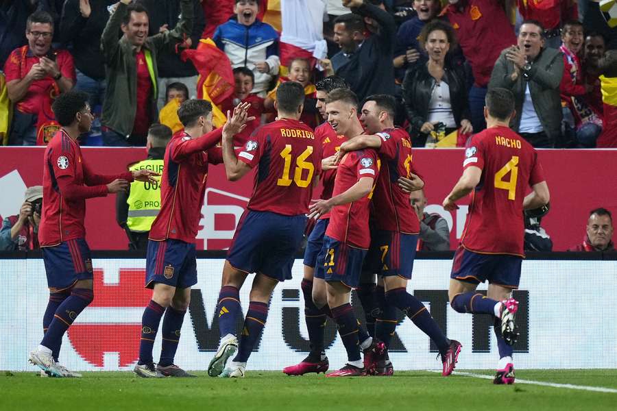 Dani Olmo is congratulated by his Spain teammates after opening the scoring against Norway