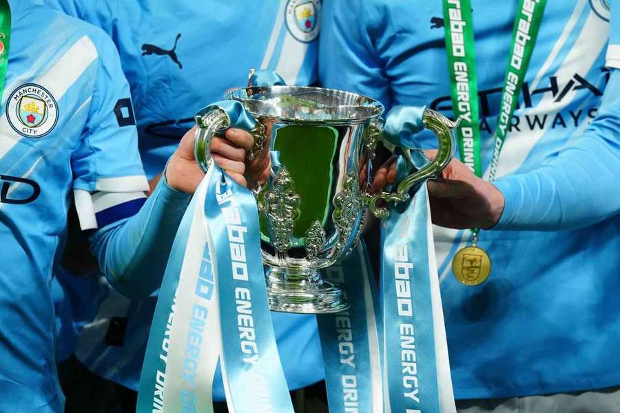 Manchester City players hold the EFL Cup at Wembley Manchester City players hold the EFL Cup at Wembley