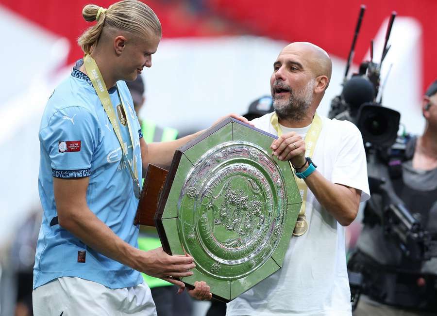 Erling Haaland (L) and Guardiola with the Community Shield