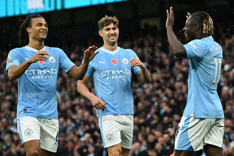 Manchester City's Belgian midfielder #11 Jeremy Doku (R) celebrates scoring the team's third goal 