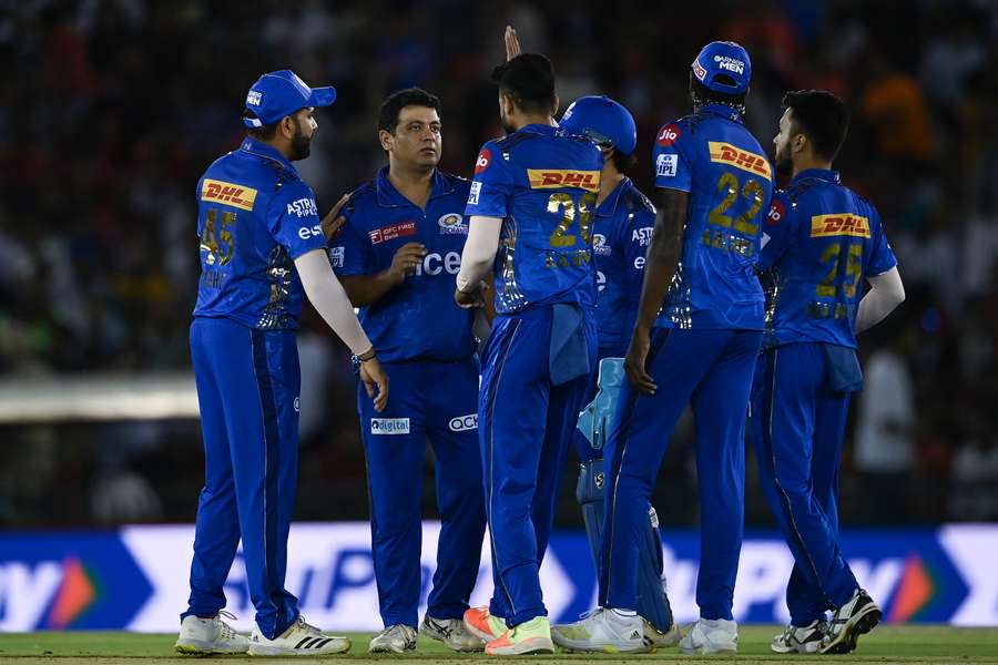 Mumbai Indians' Piyush Chawla (2L) celebrates with teammates after taking the wicket of Punjab Kings' Shikhar Dhawan