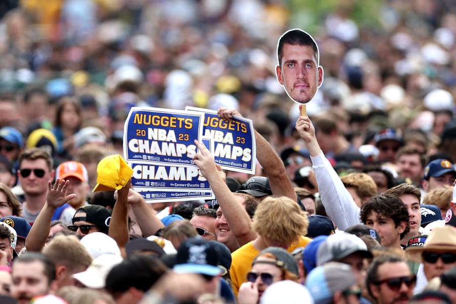 Fans hold up a cut-out of Nikola Jokic