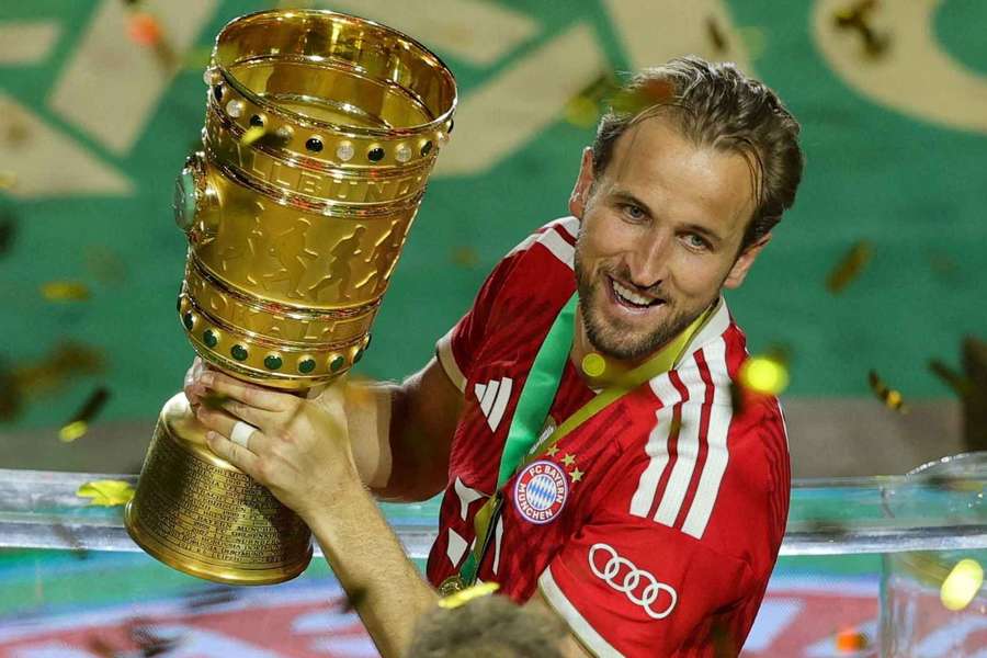 Bayern Munich's Harry Kane carries the trophy as he celebrates winning the DFB Cup Bayern Munich's Harry Kane carries the trophy as he celebrates winning the DFB Cup