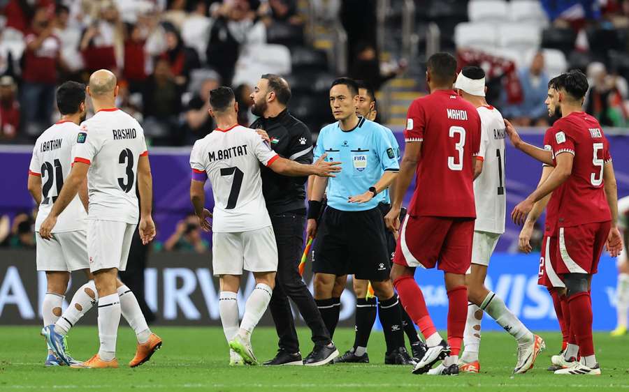 Palestine's Musab Battat remonstrates to the match officials referee after the match