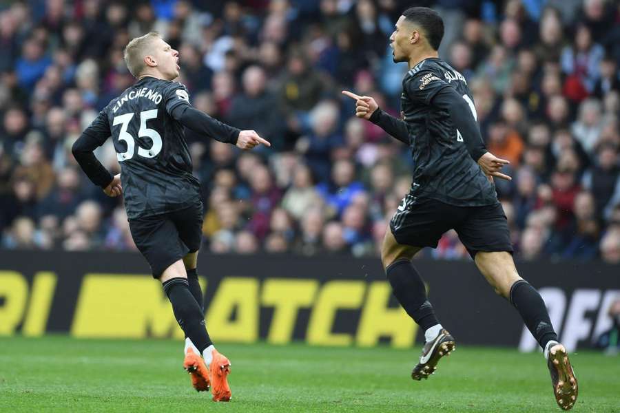 Zinchenko (left) and Saliba (right) celebrate a goal