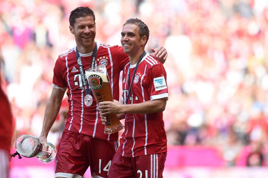 Bayern Munich teammates Philipp Lahm (R) and Xabi Alonso (L) celebrate together with a beer after their final match in May 2017