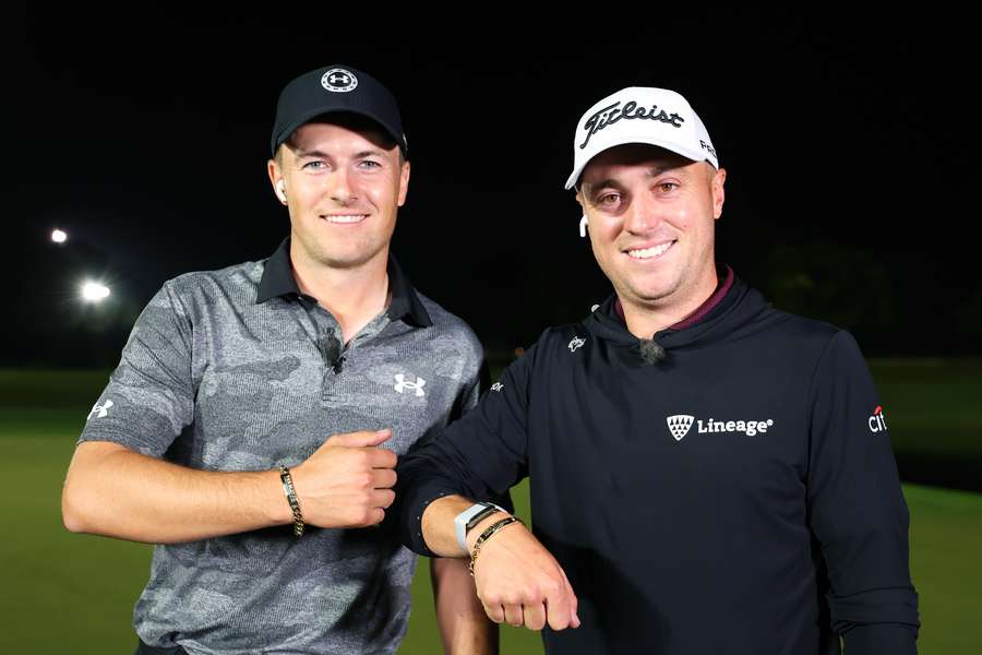 Jordan Spieth and Justin Thomas celebrate with their bracelets after defeating Tiger Woods and Rory McIlroy