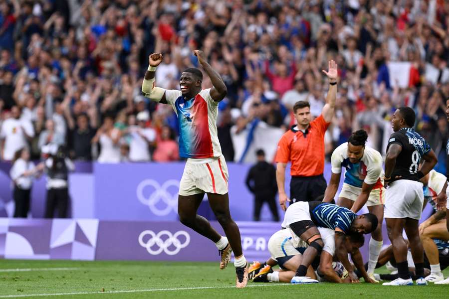 Andy Timo celebrates after an Antoine Dupont try