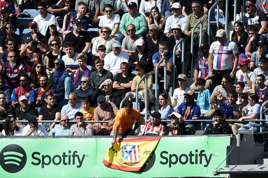 Un aficionado del Barça retiró la bandera española de un seguidor rojiblanco ayer en el Camp Nou