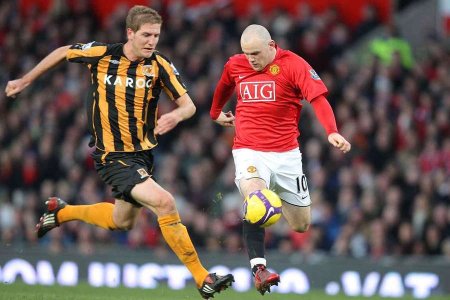 Michael Turner competing with Wayne Rooney