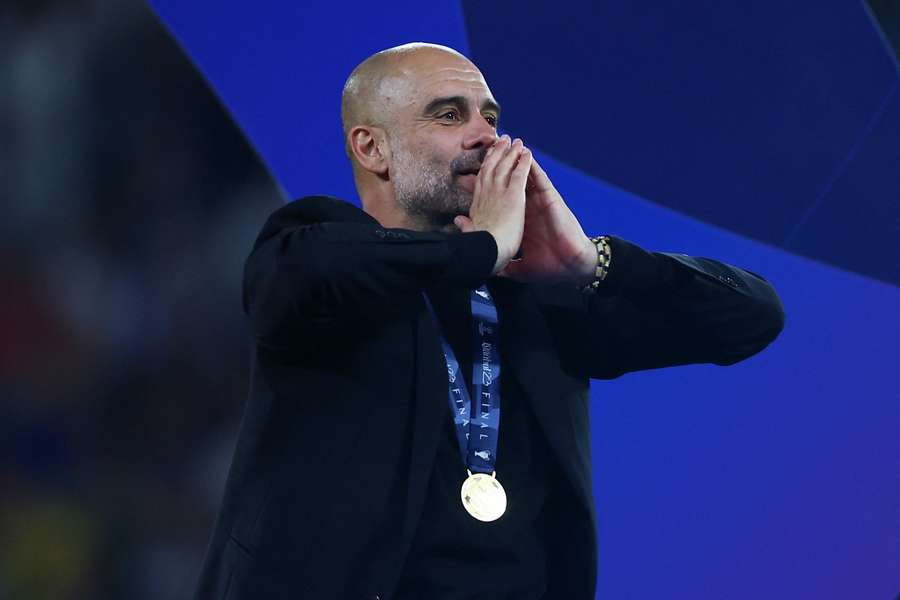 Pep Guardiola reacts after winning the Champions League with Manchester City