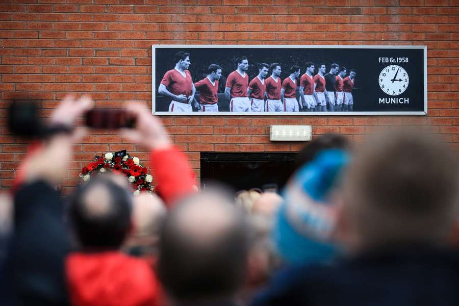 Manchester United's supporters gather in front of the memorial for the 