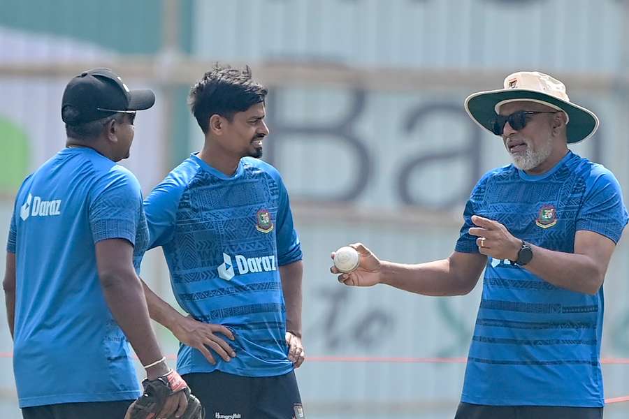 Bangladesh coach Chandika Hathurusingha (R) speaks to some of his players