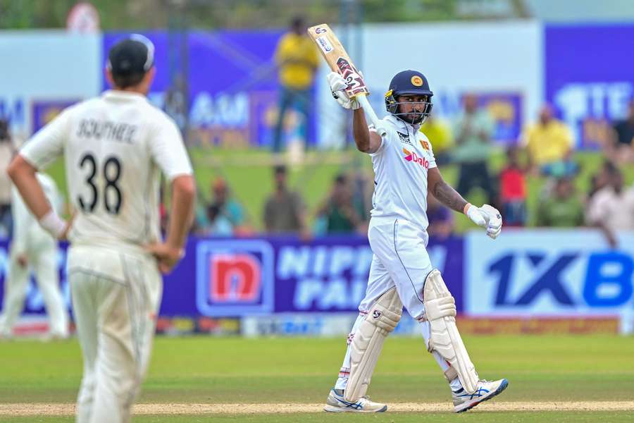 Kamindu Mendis celebrates after reaching the milestone