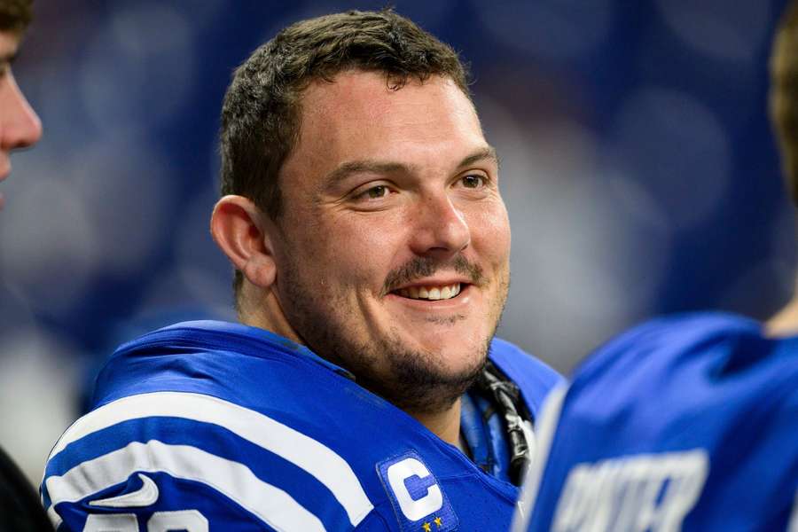 Former Colts center Ryan Kelly smiles on the sideline