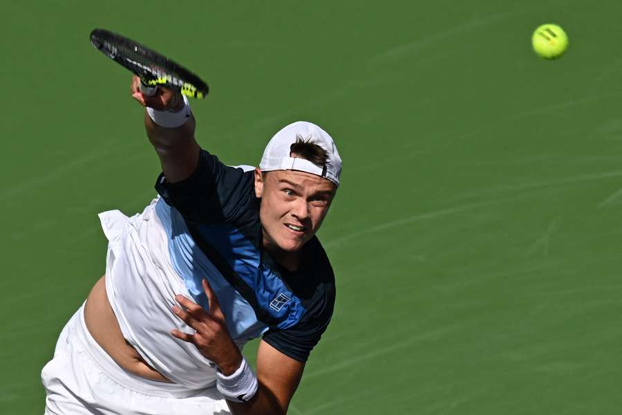 Denmark’s Holger Rune serves to Russia’s Daniil Medvedev during the men’s singles semi-final 