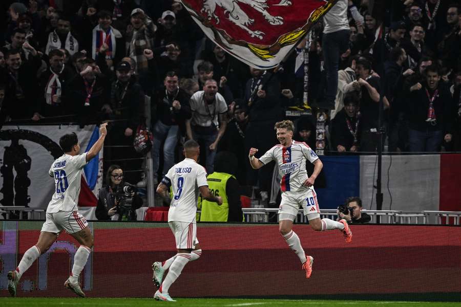 Lyon's Czech midfielder Pavel Sulc celebrates with teammates after scoring