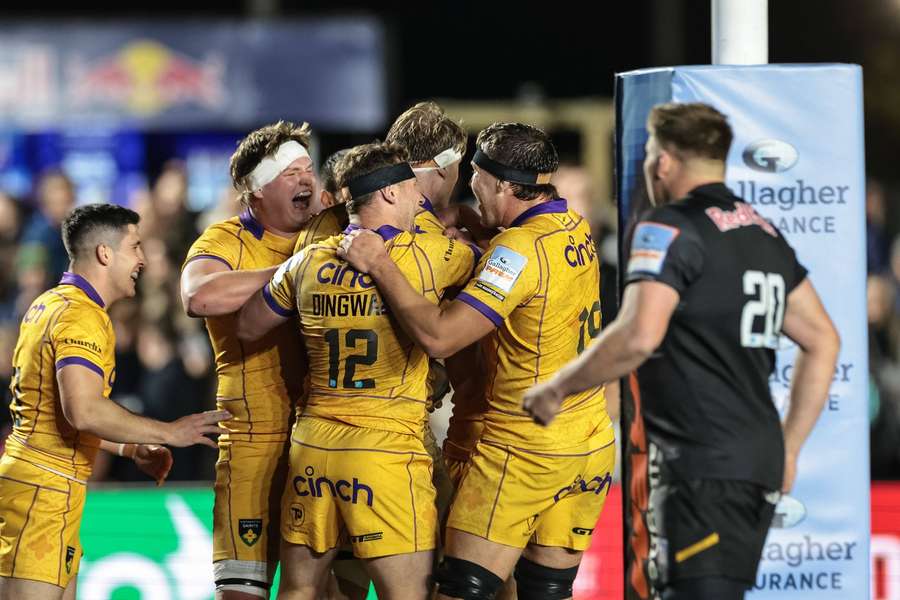 Northampton players celebrate after Alex Coles goes over for a try against Newcastle Red Bulls