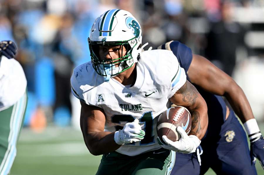 Tulane running back Makhi Hughes rushing through Navy defenders