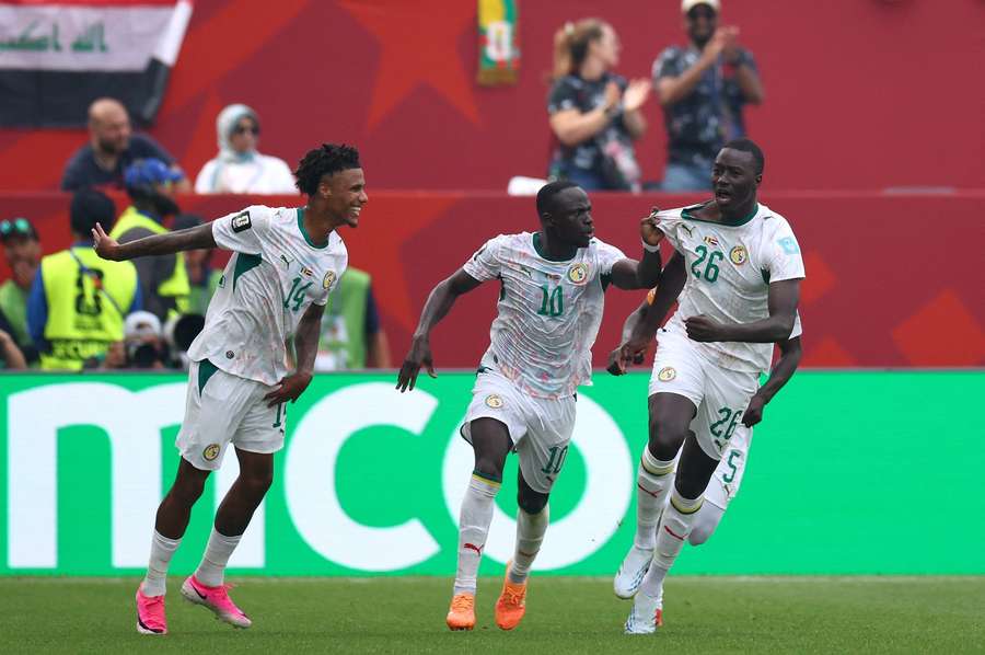 Senegal's Pape Gueye celebrates with teammates Sadio Mane and Ismail Jakobs after scoring