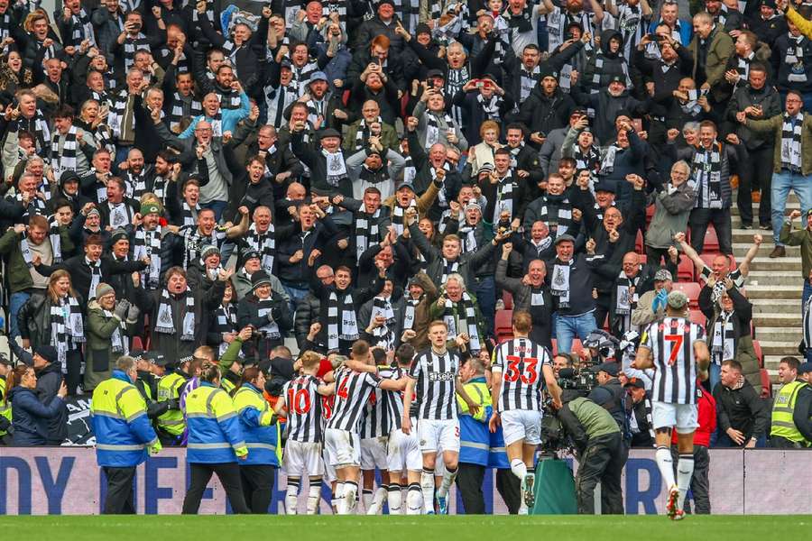 Newcastle players and fans celebrate