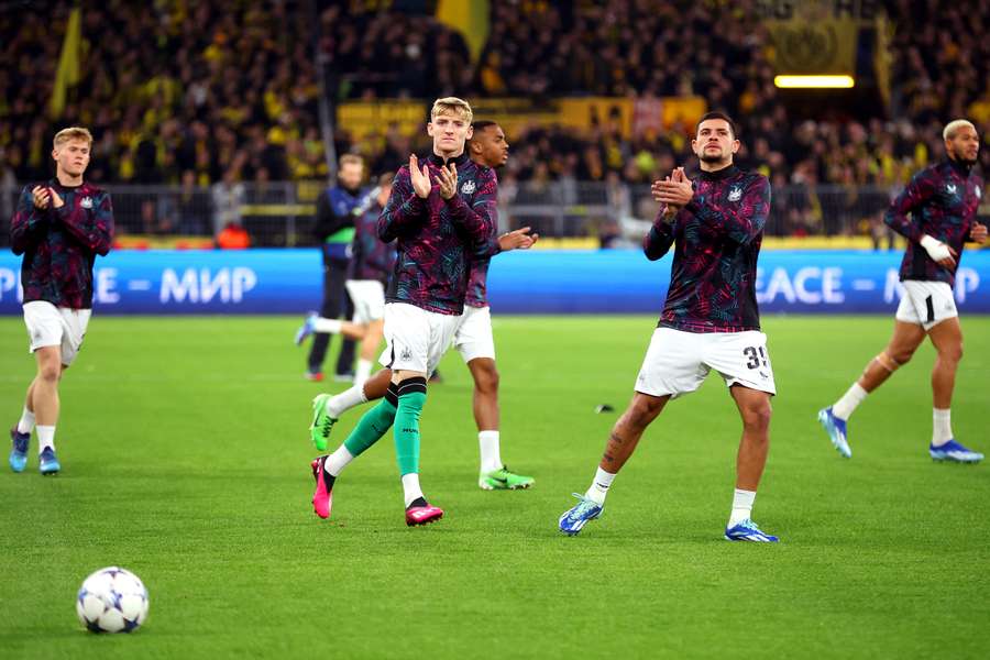 Newcastle players applaud their fans prior to their match against Dortmund