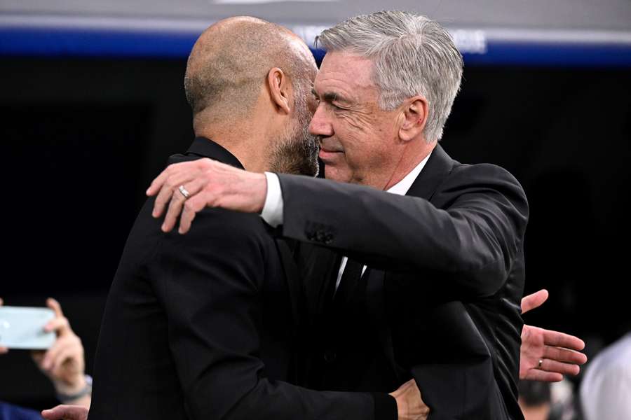 Manchester City's Spanish manager Pep Guardiola (L) and Real Madrid's Italian coach Carlo Ancelotti hug prior the UEFA Champions League semi-final first leg football match between Real Madrid CF and Manchester City