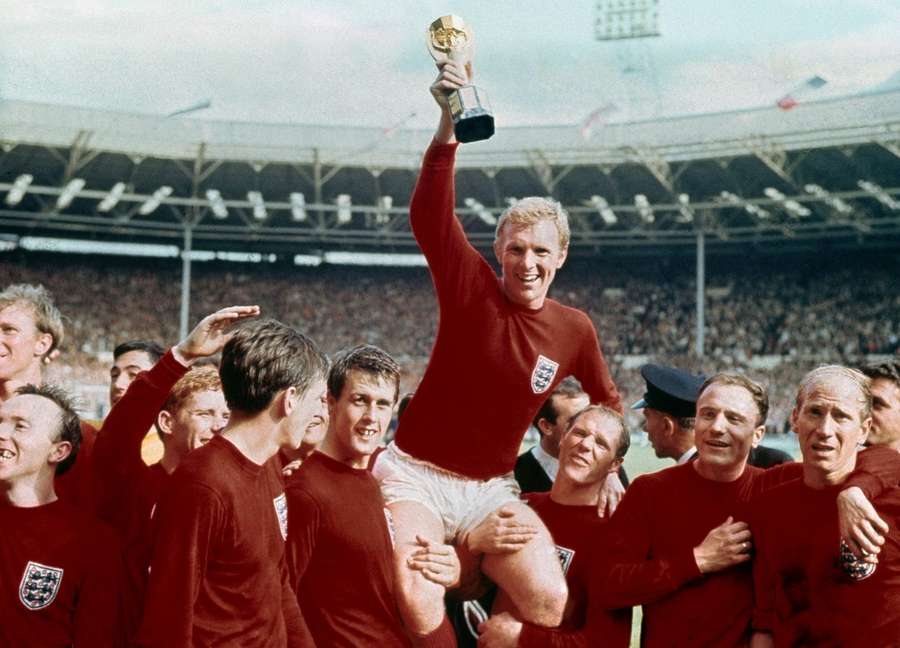 Bobby Charlton (R) celebrates winning the World Cup in 1966