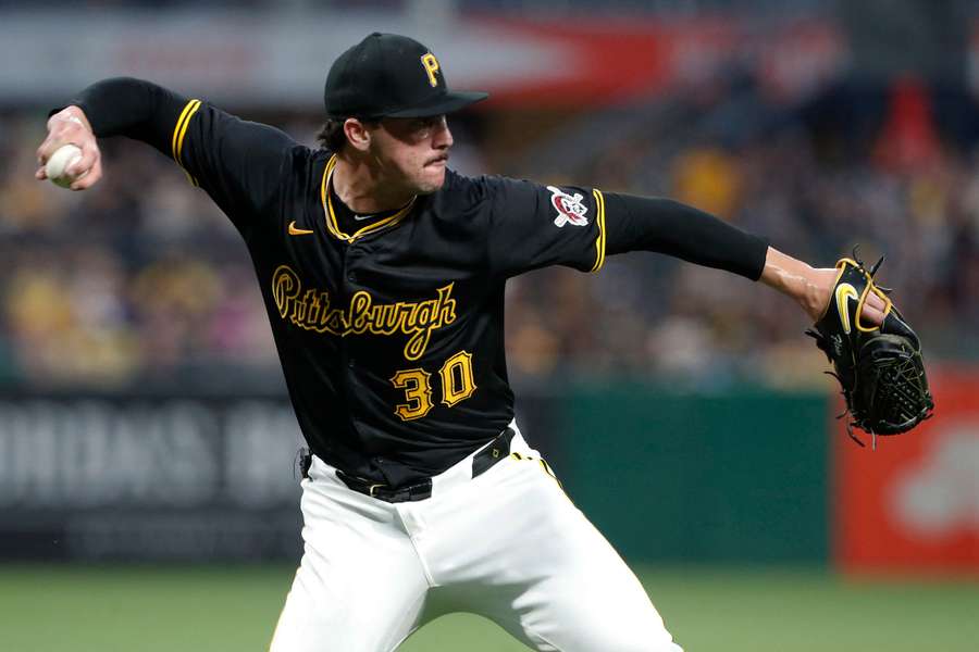 Pittsburgh Pirates starting pitcher Paul Skenes throws to first base to retire Cincinnati Reds catcher Tyler Stephenson