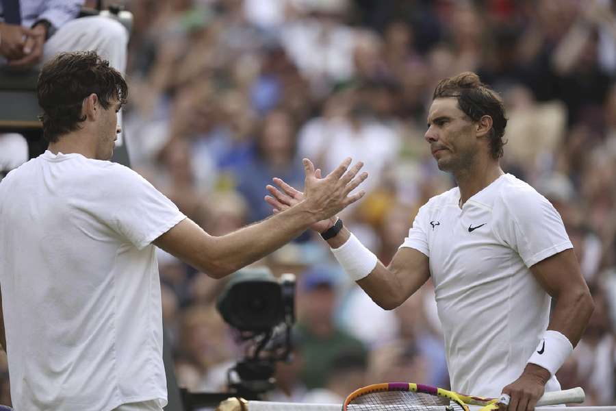 Nadal (R) and Fritz at the net