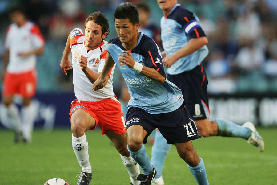 Kazuyoshi Miura tussles for the ball with Massimo Murdocca of the then-Queensland Roar in 2005!