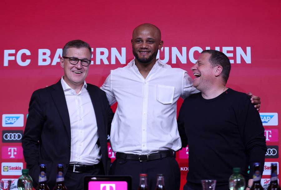 New Bayern Munich coach Vincent Kompany poses for a photograph with CEO Jan-Christian Dreesen and director of sports Max Eberl