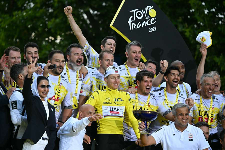 Tadej Pogacar celebrates with his team after winning the 112th edition of the Tour de France
