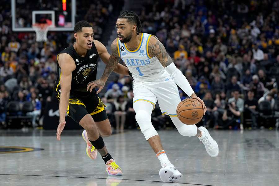 D'Angelo Russell #0 of the Los Angeles Lakers dribbles past Jordan Poole #3 of the Golden State Warriors