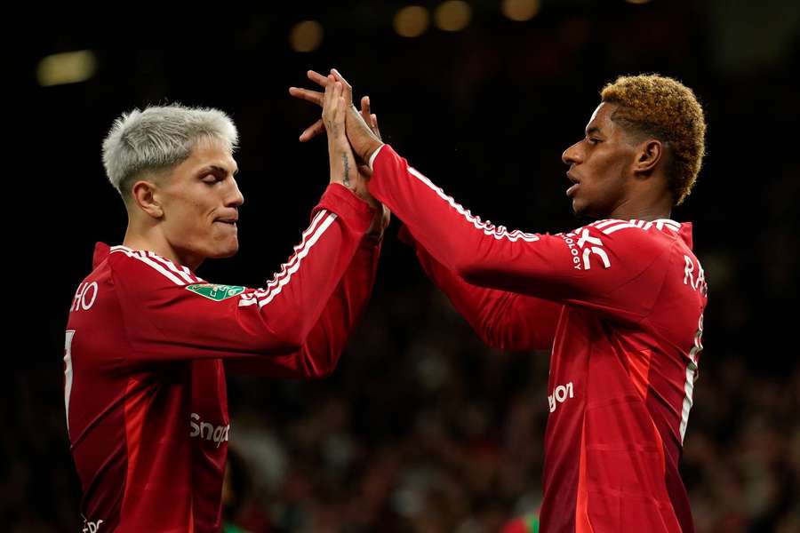 Manchester United's Marcus Rashford celebrates with Manchester United's Alejandro Garnacho, left, after scoring the fifth goal