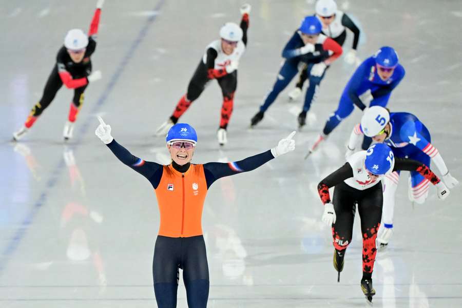 The Netherlands' Marijke Groenewoud crosses the line in the women's mass start ahead of Canada's Ivanie Blondin and the USA's Mia Maganello