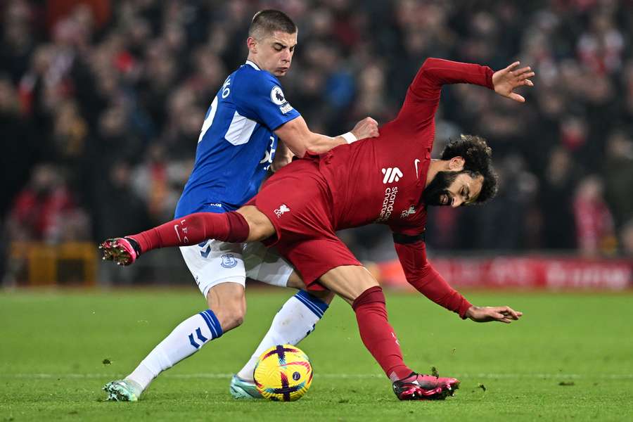 Vitaliy Mykolenko and Mo Salah tussle for the ball