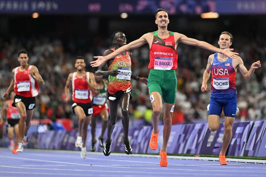 Morocco's Soufiane El Bakkali celebrates as he crosses the finish line to win the men's 3000m steeplechase final