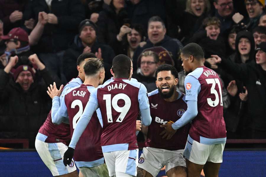 Aston Villa's Brazilian midfielder #06 Douglas Luiz (2R) celebrates after scoring the equalising goal