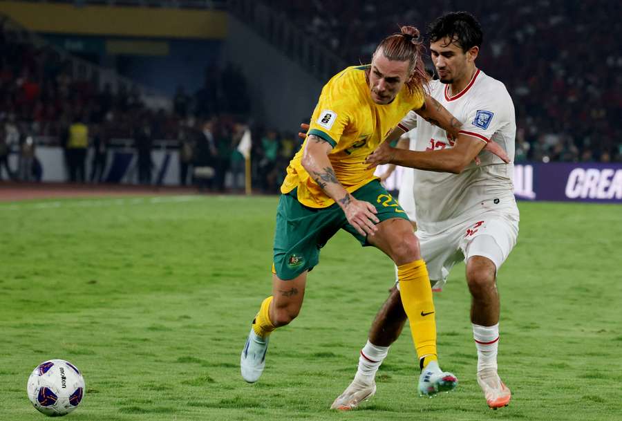 Australia's Jackson Irvine in action with Nathan Tjoe a On of Indonesia