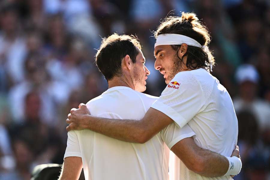 Murray (L) and Tsitsipas embrace after their match