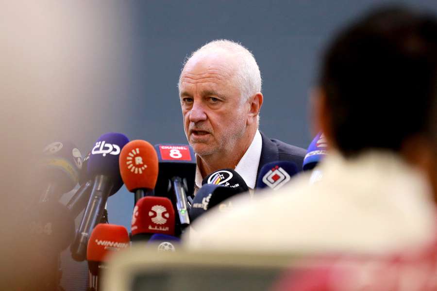 Graham Arnold speaks to reporters at a press conference in Baghdad. 