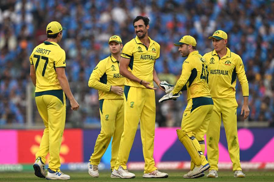 Australia's Mitchell Starc (C) celebrates with teammates after taking the wicket of India's KL Rahul