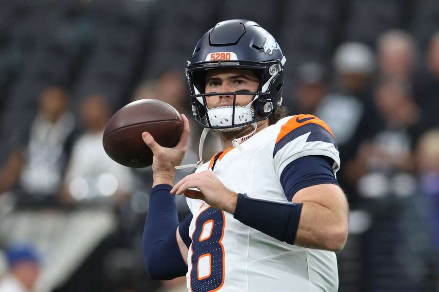 Broncos QB Jarrett Stidham warms up before a game