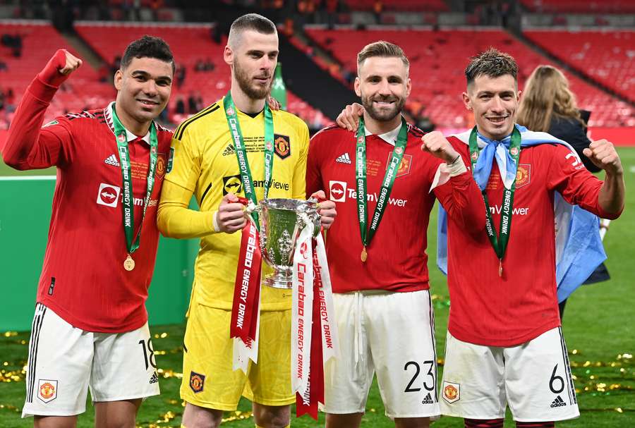 Manchester United players celebrate after their victory in the English League Cup final 