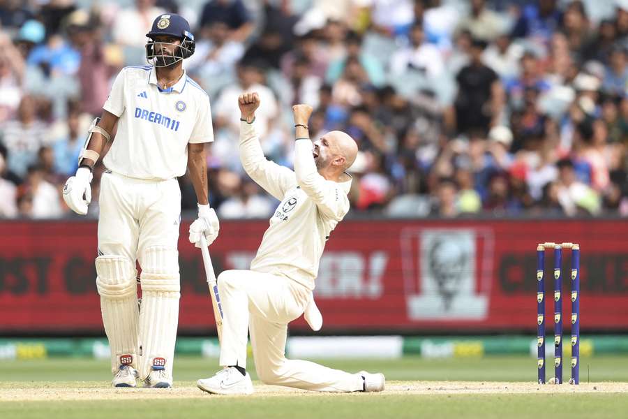 Australia's Nathan Lyon (R) celebrates the final wicket of India's Mohammed Siraj