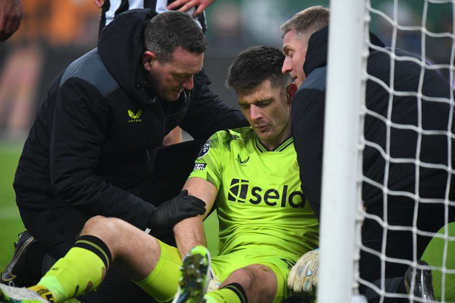 Nick Pope receives treatment after being injured against Man Utd