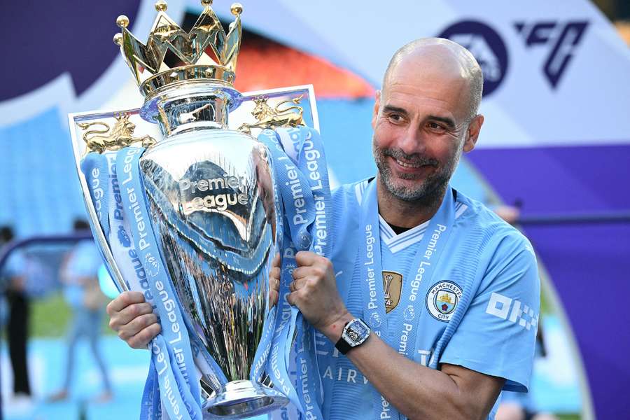 Manchester City's Spanish manager Pep Guardiola poses with the Premier League trophy
