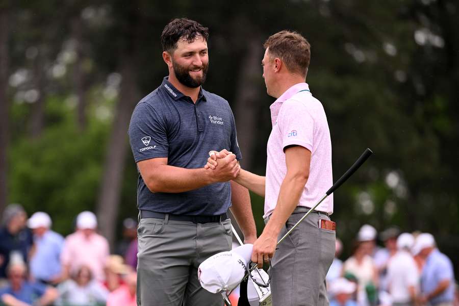 Jon Rahm and Justin Thomas shake hands on the 18th green