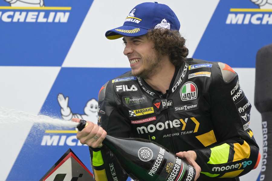 Marco Bezzecchi celebrates his first win on the podium